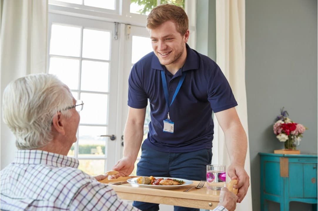 A carer helping an older person with daily personal care tasks