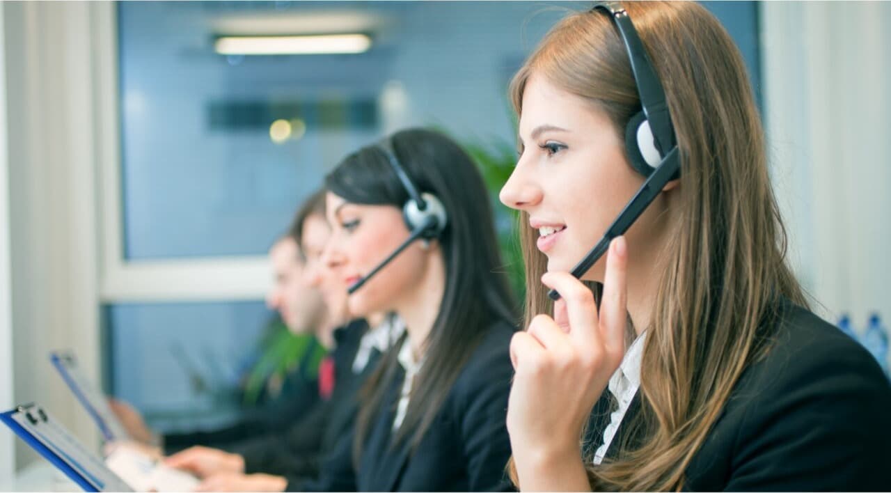 A care coordinator speaking warmly on the phone, ready to help