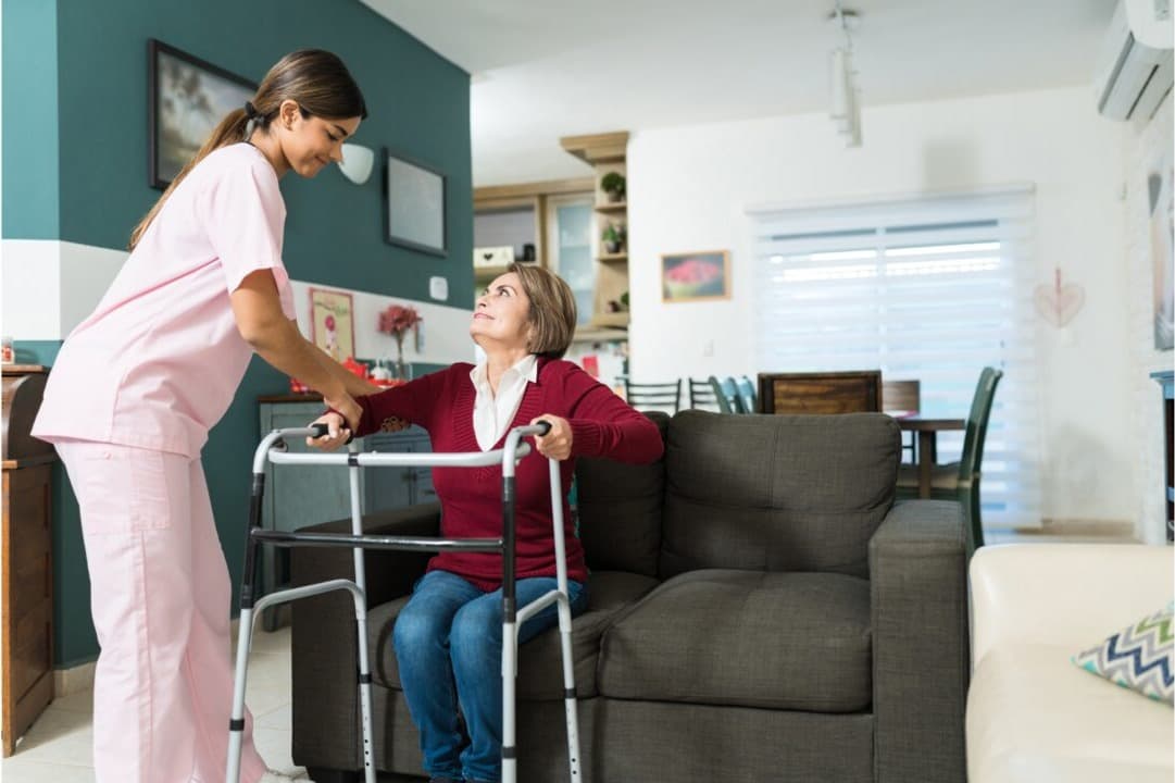 A carer helping an older woman stay active and comfortable at home